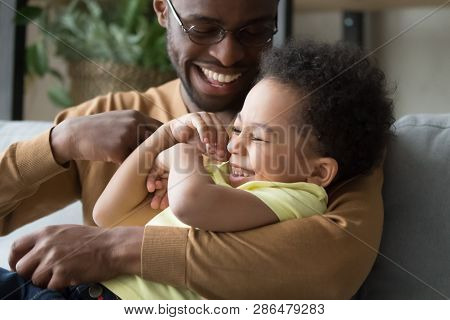 Affectionate Loving African Dad Holding Tickling Child Toddler Son