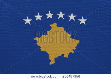 Kosovo flag on canvas. Patriotic background. National flag of Kosovo