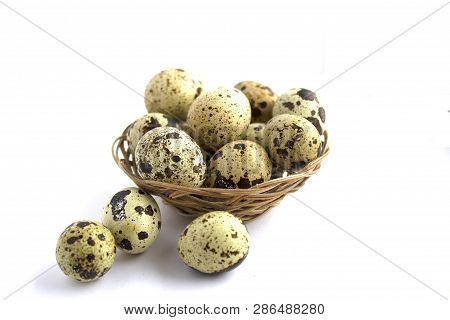 Quail Eggs In A Basket On A White Background. Healthy Lifestyle. Diet Food.