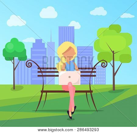 Woman Sitting On Bench In City Park On Background Of Skyskrapers With Modern Laptop In Free Wi-fi Zo