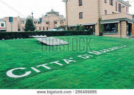 Maranello, Italy - 03 26 2013: Inscription City Of Maranello On The Lawnview Of The Streets Of Maran