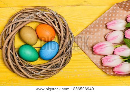 Spring Vibes. Easter Is Coming. Colorful Bright Eggs And Bouquet Fresh Tulip Flowers On Yellow Backg