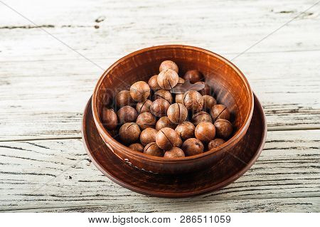 Macedonian Nuts On A Wooden Plate On The Background Of A Textural Wooden Table. Macedonian Nuts Clos
