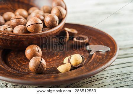 Macedonian Nuts On A Wooden Plate On The Background Of A Textural Wooden Table. Macedonian Nuts Clos