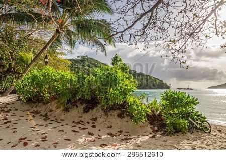 Sunset At Port Launay, Mahe Island, Seychelles. View On White Sandy Beach And Turquoise Lagoon.