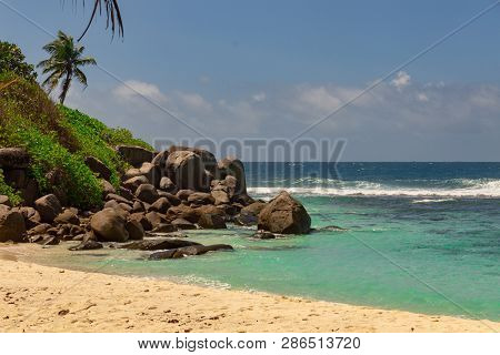 Beautiful Beach On Island Mahe, Seychelles. Turquoise Water Of The Indian Ocean And Palms And Famous