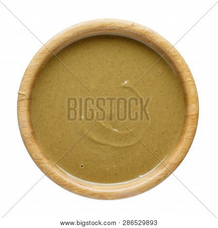 Natural Paste From Pumpkin Seeds In Wooden Bowl Isolated On White. Pumpkin Urbech, Pumpkin Seed Butt
