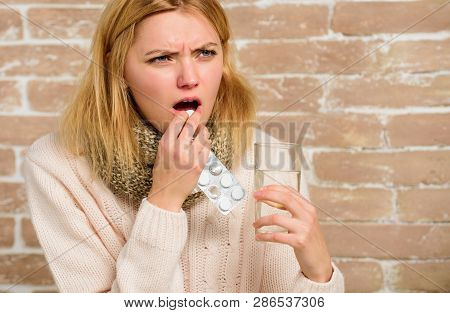 Pills For Breaking Fever. Headache And Fever Remedies. Woman Tousled Hair Scarf Hold Glass Water And