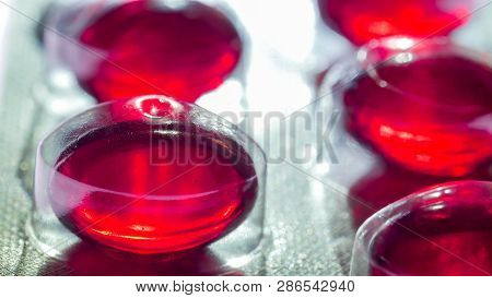 Plastic Cover On The Red Capsules On A Macro Shot From The Medicine Pack