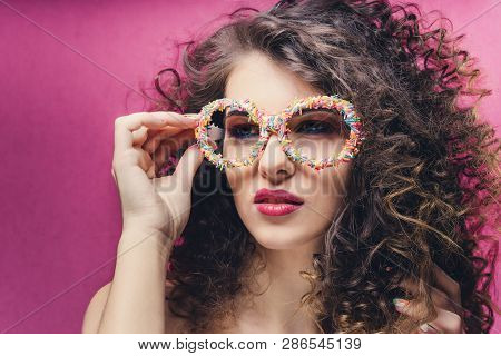 Beautiful Girl With Colourful Manicure In Confectionery Dressing Glasses