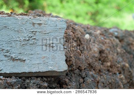 Closeup Broken Concrete Structure With Reinforcement Steel Lay On The Soil Ground
