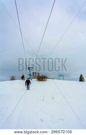 A Photographer With A Backpack On His Back Climbs To The Top Of The Mountain In The Carpathians