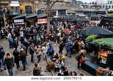 LONDON, UK - DECEMBER 30, 2018: Visitors at Camden Lock. Camden Lock, Camden Market, and streets nearby are the fourth-most popular attraction in the city, attracting 100,000 people each weekend