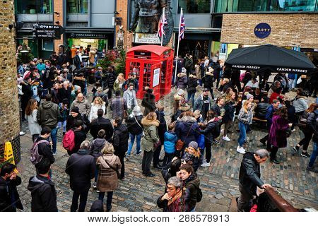 LONDON, UK - DECEMBER 30, 2018: Visitors at Camden Lock. Camden Lock, Camden Market, and streets nearby are the fourth-most popular attraction in the city, attracting 100,000 people each weekend