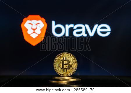 Bitcoin Coins With Brave Browser Logo On A Laptop Screen. Cryptocurrency And Blockchain Adoption Get