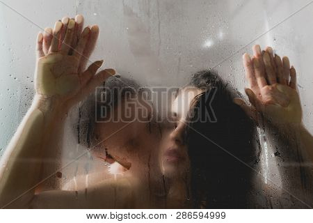 Selective Focus Of Passionate Naked Man Kissing Attractive Woman In Shower Cabin