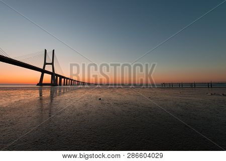 Peaceful Atmosphere At Vasco Da Gama Bridge In Lisbon During Sunrise. Ponte Vasco De Gama, Lisboa, P