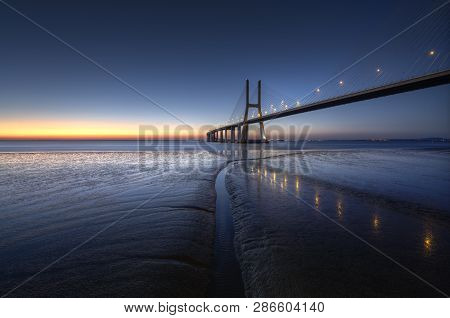 Peaceful Atmosphere At Vasco Da Gama Bridge In Lisbon During Sunrise. Ponte Vasco De Gama, Lisboa, P