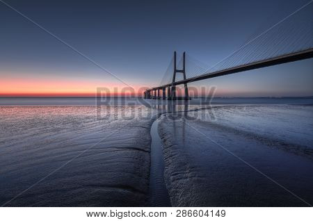 Peaceful Atmosphere At Vasco Da Gama Bridge In Lisbon During Sunrise. Ponte Vasco De Gama, Lisboa, P