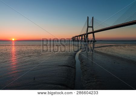 Peaceful Atmosphere At Vasco Da Gama Bridge In Lisbon During Sunrise. Ponte Vasco De Gama, Lisboa, P