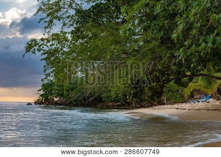 Calm Clear Waters On White Sand Tropical Island Beach. Peaceful, Serene. Sunset In The Background. N