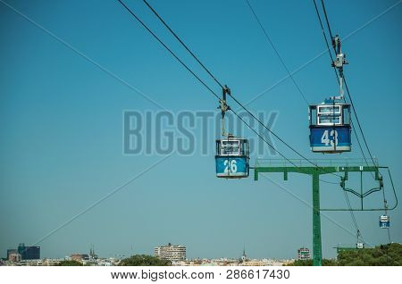Cable Car Gondola Passing Through Big Supporting Towers Over Treetops, In A Sunny Day At The Telefer