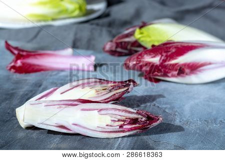 Group Of Fresh Green Belgian Endive Or Chicory And Red Radicchio Vegetables, Also Known As Witlof Sa