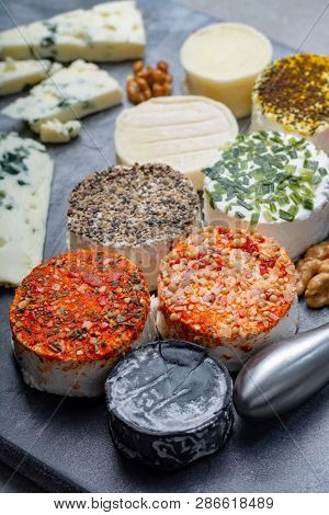 Assortment Of French Fresh White Soft Goat Cheeses With Different Tastes Topping Made With Herbs, Pa