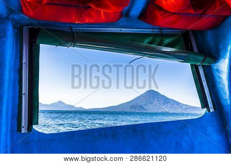 Open Boat Window Frames View Of Atitlan & Toliman Volcanoes With Cerro De Oro In Front On Lake Atitl