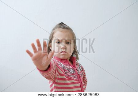 Stop Sign, Toddlers Palm Saying Stop With Hands In Front Of Himself. Suspend Of Constraint On Childr