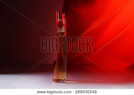 Prague, Czech Republic- January 22, 2019. Perfume KENZO bottle on red background.  Kenzo Flower Perfume