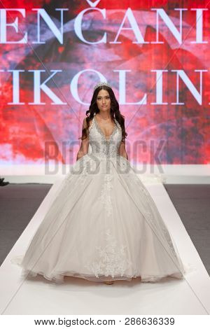 ZAGREB, CROATIA - FEBRUARY 02, 2019: Fashion model in a wedding dress walking down the runway at the Wedding fair