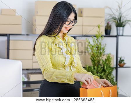 Young Attractive Asian Businesswoman, Long Black Hair, Wearing Glasses, Yellow Blouse, Recheck Order