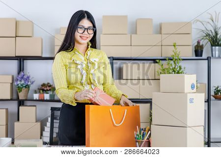 Young Attractive Asian Businesswoman, Long Black Hair, Wearing Glasses, Yellow Blouse, Recheck Order