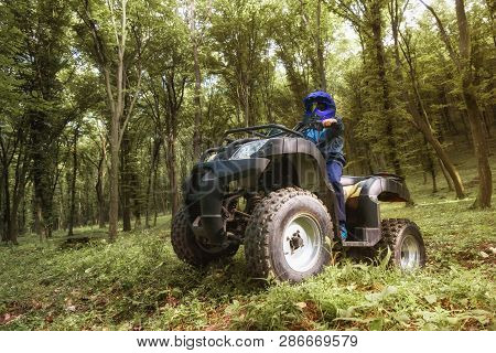 The Boy Is Traveling On An Atv.
