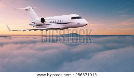 Small private jetplane flying above beautiful clouds. Travel and transportation concept.