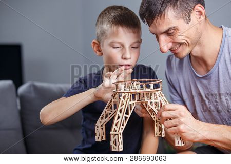 Young Boy Assembling Constructor With His Father