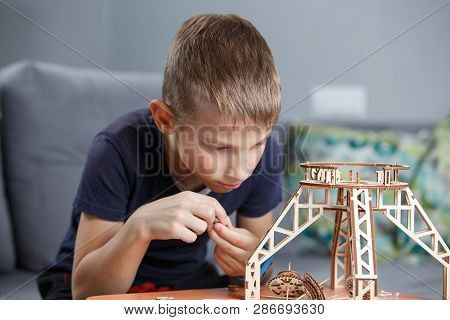 Young Boy Playing With Eco Wooden Constructor