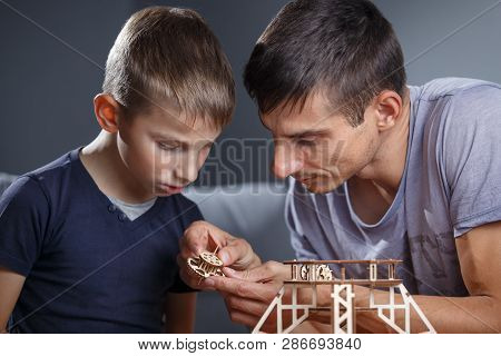 Young Boy Assembling Constructor With His Father