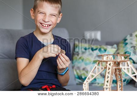 Young Boy Playing With Eco Wooden Constructor