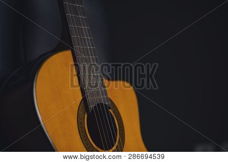 Yellow  Acustic Guitar With Vintage Black Background