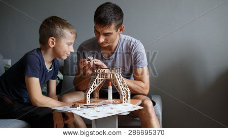 Young Boy Assembling Constructor With His Father