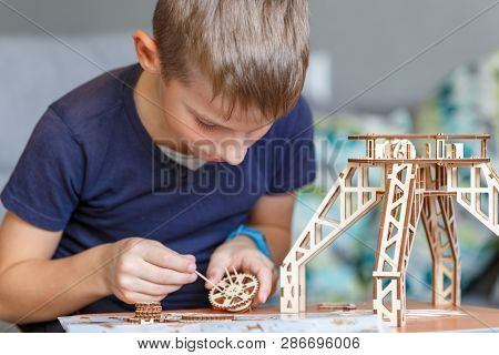 Young Boy Playing With Eco Wooden Constructor