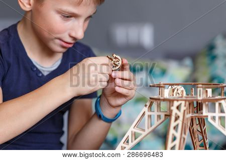 Young Boy Playing With Eco Wooden Constructor
