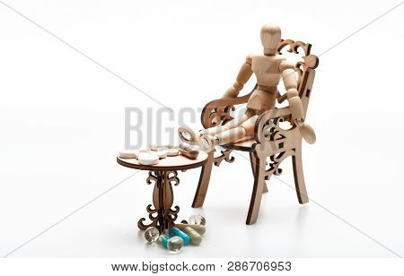 Medication Regimen. Health Care And Medical Treatment. Pills On Tiny Wooden Table. Human Wooden Dumm