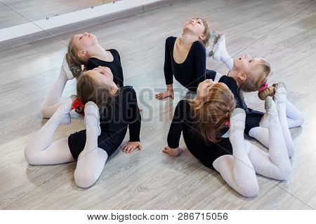 Little Girls Do Gymnastics In A Dance Class. The Concept Of Sport, Education, Childhood, Hobbies And