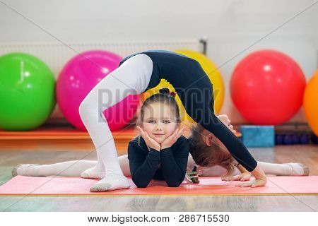 Two Young Children Train In A Gym Class. The Concept Of Sport, Education, Childhood, Hobbies And Dan