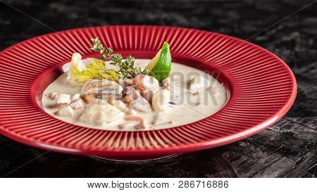 The Concept Of American Cuisine. Clam Chowder Potato Soup With Sea Food, Mussels, Salmon. Fish Broth