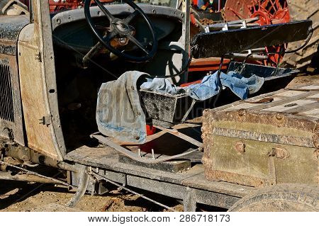 An Old Car Has Been Converted Into An Old Jalopy Combining Various Mechanical Items Into A Vehicle.