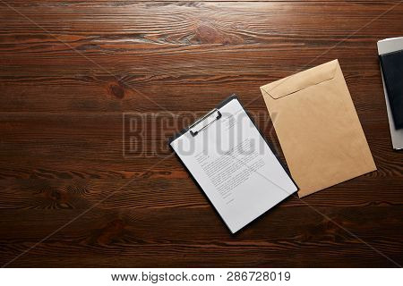 Top View Of Documet On Clipboard And Envelope With Copy Space